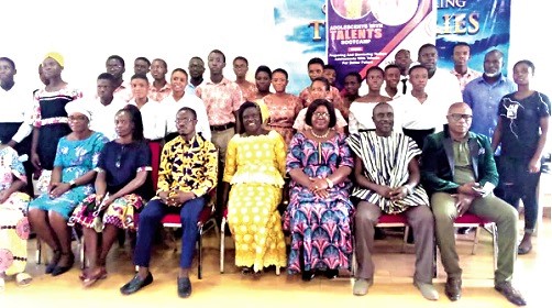 Gifty Mussey (seated 3rd from right), the Adentan Municipal Director of Education, with other invited guests and students after the event