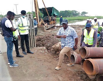 Kwasi Amoako-Attah (right), Minister of Roads and Highways inspecting the La Beach road project