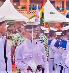 A BMI School cadet officer leading Kwadwo Asare-Bediako, the Managing Director of the institute, Matilda Asare-Bediako, his wife, (both partly covered) to inspect a guard of honour.