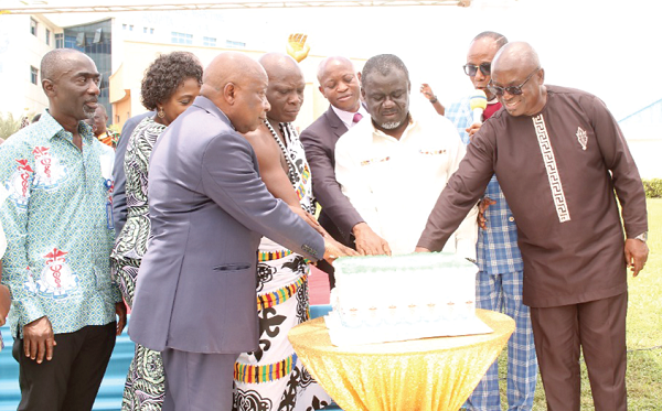 Kwaku Ofori-Asiamah (3rd from right), Transport Minister, being assisted by dignitaries, including Kwaku Agyemang-Manu (3rd from left), Health Minister, to cut the anniversary cake. Picture: DELLA RUSSEL OCLOO