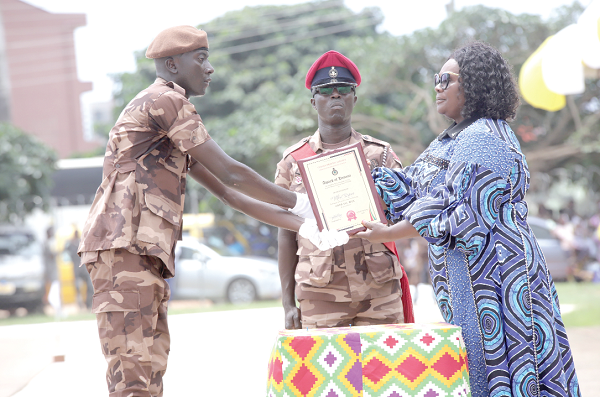  Naana Eyiah (right), a Deputy Minister for the Interior, presenting the Overall Best Recruit Officer award to Prince Mbri (left), at the ceremony. Picture: Samuel Tei Adano