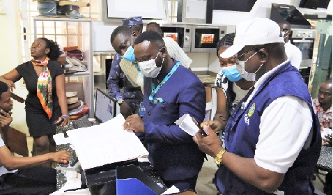Some officials of the Ghana Revenue Authority inspecting the tax records of a business setup. Picture: ELVIS NII NOI DOWUONA