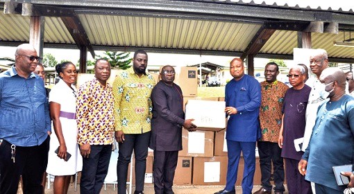 Samuel Okudzeto-Ablakwa (5th from right) presenting the items to Dr John Tamapoure