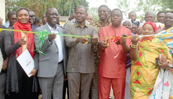 • Kwasi Adu-Gyan (2nd from right), Bono East Regional Minister,  cutting the tape to inaugurate the medical store (right). With him include Dr Patrick Kuma-Aboagye (middle), Director-General of the GHS; Dr Wilfred Ochan (2nd from left), Country Representative of UNFPA, and Elizabeth Williams (left), USAID Representative in charge of Health System Strengthening