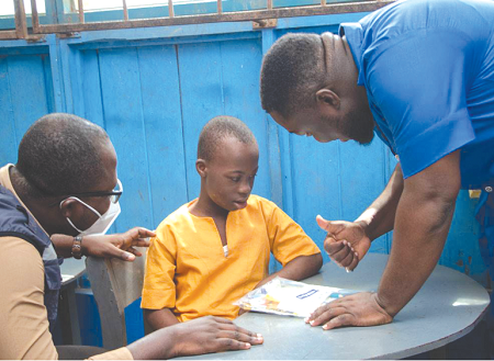   A young learner at the Dzorwulu Special School being assisted to learn