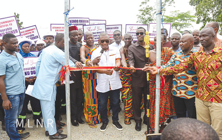 George Mireku Duker (arrowed), Deputy Minister of Lands and Natural Resources, being assisted by Kwabena Okyere Darko-Mensah (4th from right), Western Regional Minister, and some dignitaries to cut a tape to commission the  Community Mining Scheme (CMS) at Wassa Afransie in the Western Region