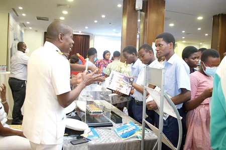 Naval Capt. Kwasi K. Donkor explaining a point to a student at the exhibition. Picture: DELLA RUSSEL OCLOO