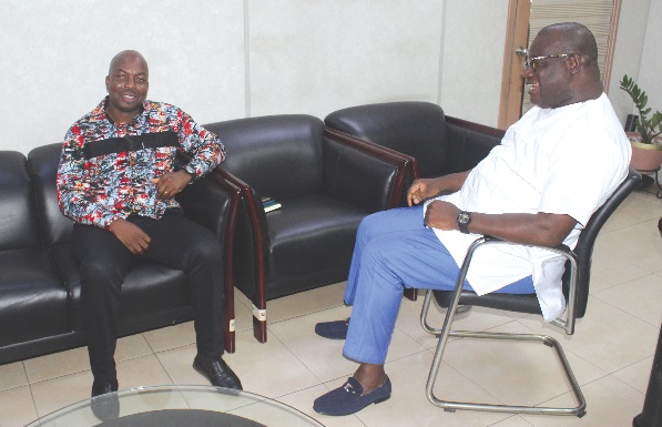 Theophilus Yartey (right), Editor, Graphic, interacting with Dr Elikplim Kwabla Apetorgbor, CEO, Independent Power Generators, Ghana