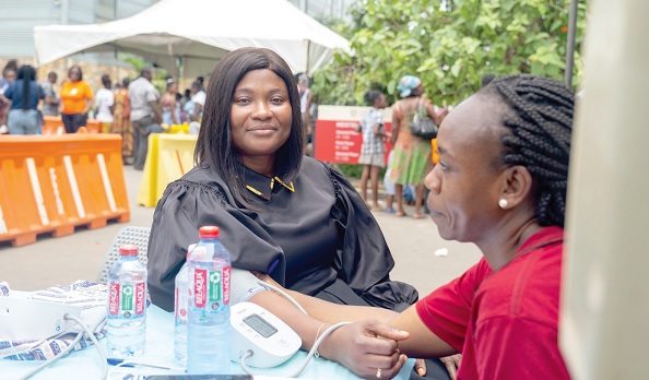 Kaakie Mann (left), Chief Executive of the Ga East Municipal Assembly, was among the beneficiaries of the health screening exercise