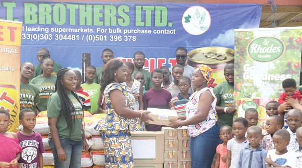 • Eunice Aku Tetteh (2nd from left) presenting the items to Comfort Asamoah, Mothers Representative of the orpahange