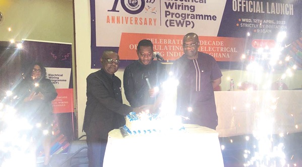 • Herbert Krapah (middle),  with Prof. Ebenezer Oduro-Owusu (left) and Oscar Amonoo-Neizer (right), Executive Secretary of the Energy Commission, cutting the cake to launch the 10th anniversary of the Electrical Wiring Programme 