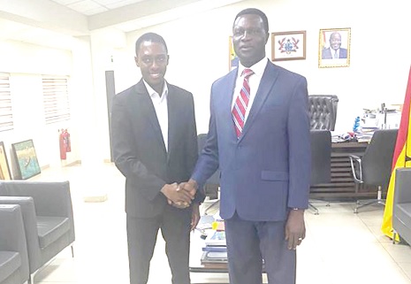 • Dr Yaw Osei Adutwum (right), Minister of Education, congratulating Dr Nathaniel Nii Codjoe