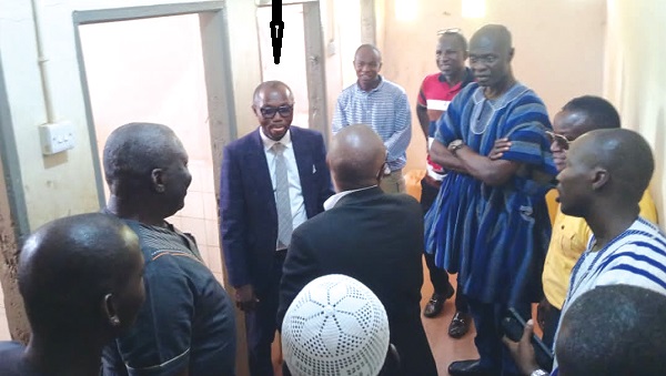 Stephen Kwaku Owusu (arrowed), Deputy DG of GES, Shani Alhassan Shaibu (3rd from right) and other members of the delegation inspecting the toilet facility