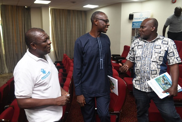 Cecil Osei (left), Deputy Chief of Party of the Ghana MSR Activity interacting with some of participants 