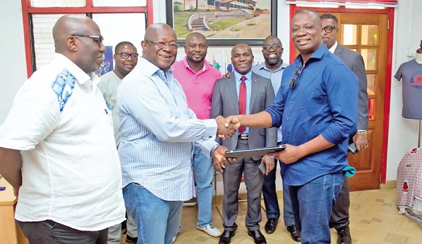 • Mohammed Baakoe (right), CEO of DRW, Canada, presenting one of the laptops to Captain Paul Forjoe, President of MOBA, while other members look on