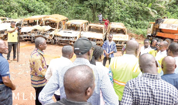 •  George Mireku Duker (arrowed), Deputy Minister, Lands and Natural Resources, being briefed on the extent of damage to the company’s properties