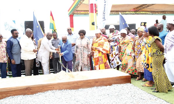 • President Akufo-Addo (4th from left) being assisted by Dr Kofi  Nsiah-Poku (3rd from left), Managing Director, DEK Vaccine Limited, to cut the sod for the manufacturing plant at Medie Kotoku in the Greater Accra Region