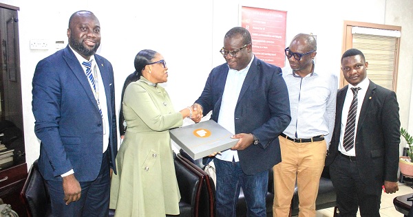 • Esi E. Mills-Robertson (2nd from left), Director, Inclusive Banking, presenting a gift to Theophilus Yartey, Editor, Graphic. With them are Eric Frempong Amponsah (left), Head of Marketing, Fidelity Bank, Maurice Quansah, Editor, Graphic Sports, and a member of staff of Fidelity Bank. Picture: ERNEST KODZI