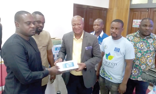 • Sam Pyne (3rd from left), Chief Executive of KMA, presenting the PoS device to a revenue collector
