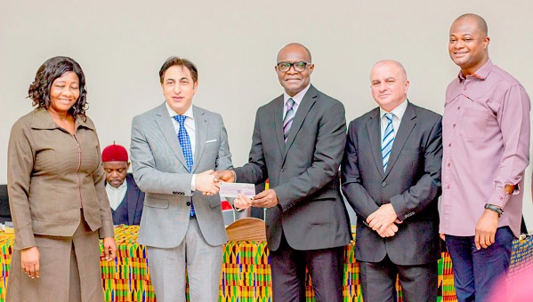 • Maher Khier (2nd from left), Lebanese Ambassador to Ghana, presenting the cheque to Prof. Daniel Ofori at the ceremony. With them include Prof. Raymond Atuguba (right)