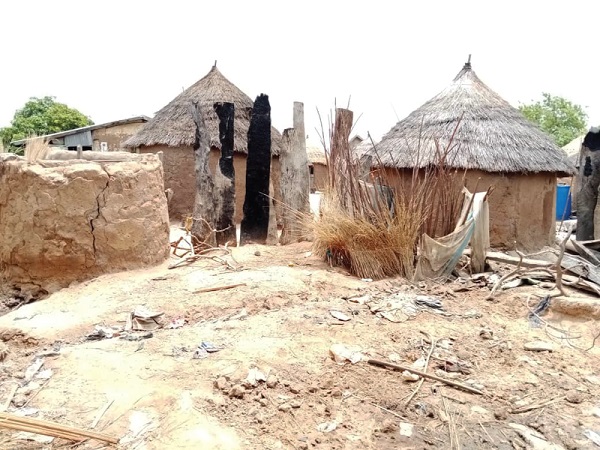Remains of some buildings that were torched during the communal clash (arrowed)