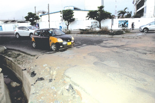 The condition of the road in front of Fan Milk Limited, at the Industrial Area in Accra. Picture: ESTHER ADJEI 