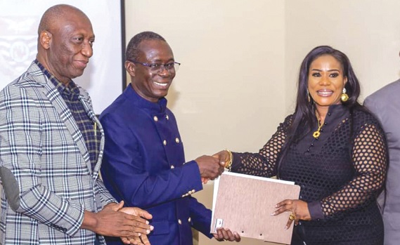 • Adelaide Araba Siaw Agyepong (right), CEO, Asian African Consortium, presenting a copy of the MoU to Prof. Johnson Nyarko Bampong, Vice Chancellor of the University of Cape Coast. With them is Jeff Teye Onyame, Registrar, UCC