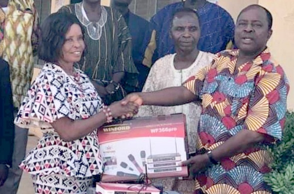 • Francis Essel Okyeahene (right), CEO of the Young Executive and Onua Francis International schools, presenting the PA system to Cecilia Aboagye, Gomoa West Director of Education