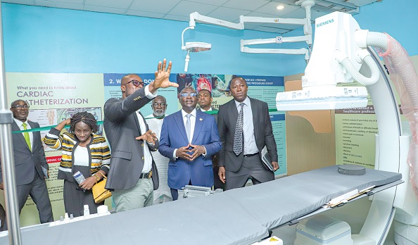 • Dr Mahamudu Bawumia (2nd from right), the Vice-President, being briefed on the equipment at the lab, while Dr Opoku Ware Ampomah  (right), CEO, Korle Bu Teaching Hospital, and some officials look on