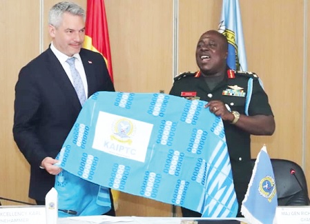 • Major General Addo Gyane presenting a KAIPTC stole to Chancellor Karl Nehammer. Picture: DELLA RUSSEL OCLOO