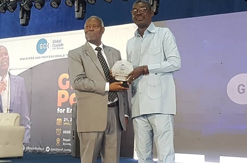   Pastor Dr W. F. Kumuyie (left), General Superintendent of the Deeper Life Bible Church, receiving his Global Lifetime Achievement award from the President of International Clergy Association Inc. (ICA), Bishop Dr Charles Abban in Accra