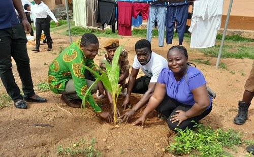 David Amevor (1st left), Koforidua Area Manager of the ASA Savings and Loans together with Clement Angmortey (2nd right), Koforidua Forestry Range Manager as well as Samuel Kusi Assan (2nd from left), Second in Command in charge of Administration of the Koforidua Prisons to plant one of the tree seedlings at premises of the prisons.