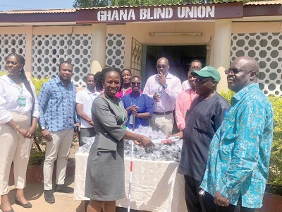 Eno Odame-Darkwa (left), HR Manager of Gokals-Laborex, presenting the white canes to George Abelse (2nd from right), the Regional President of the Ghana Blind Union 