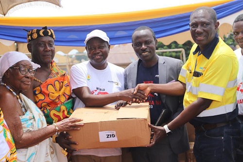 Ahmed Mohadini-Yahaya(right), acting General Manager, Asanko Gold Mine, symbolically handing over the items to Nana Opoku Nsafoa Agyemang II(2nd left), Chief of Abore, on behalf of the two districts. Those looking on include Bernard Badu Bediako(2nd right), Amansie  West District Director of Health Services.