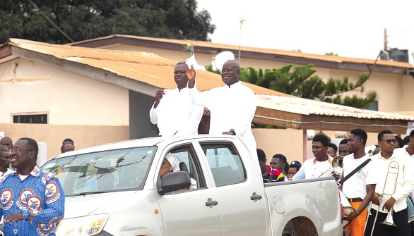 Very Rev. Fr Donkor-Baine (arrowed) responding to cheers during the procession