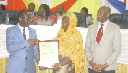 Mrs Abonyi receiving a citation on behalf of her husband, John Egya Ekow Abonyi, who served the university for 42 years