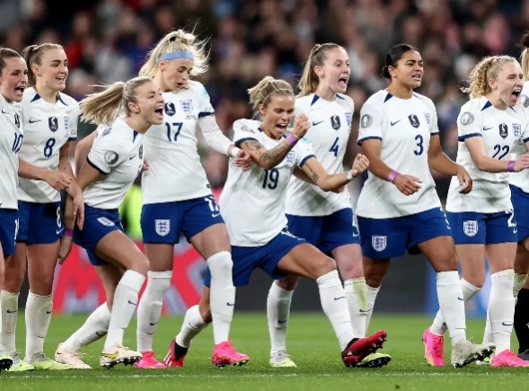 The England team celebrate after qualifying for the Round of 16