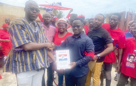 Samuel Brako-Amoafo (right) receiving the  forms  from Ayuba Tahiru Monnie, a youth representative of the NPP in the area