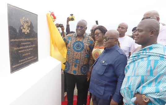 President Akufo-Addo (2nd from right) observing the plaque after inaugurating the plant at Ashaiman. With him include Freda Prempeh (middle), Minister of Sanitation and Water Resources, and Nii Annang Adjor (right),  the Ashaiman Chief.  Pictures: SAMUEL TEI ADANO