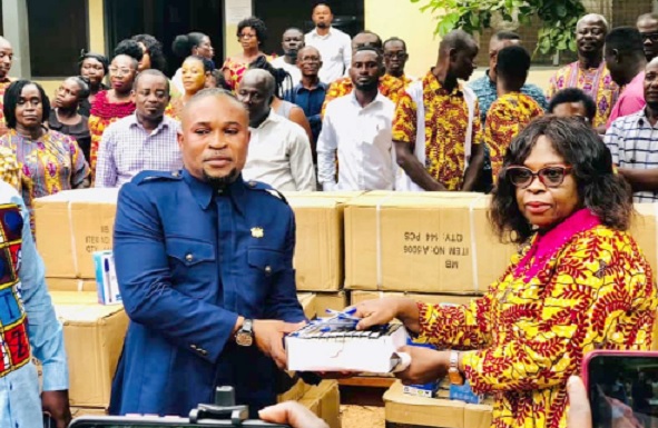 John Kwame Duodu presenting the items to Juliana Essel-Cudjoe