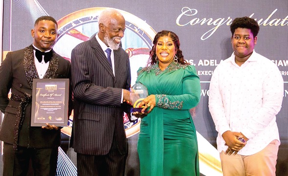 Prof. Stephen Adei (middle), a board member of the National Governance and Business Leadership, presenting  Woman Entrepreneur of the Year award to Adelaide Siaw-Agyepong