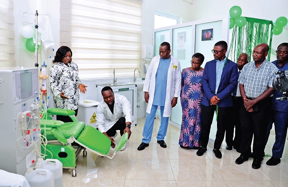 Dr Rebecca Acquaah-Arhin (left), the Medical Coordinator of Family Health Hospital, explaining the work of some of the equipment to the invited guests