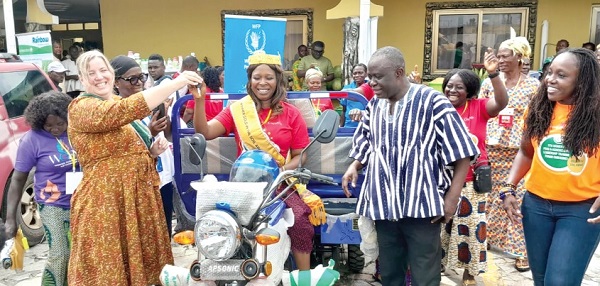 Kathleen Flynn-Dapaah (left), Head of Cooperation at the Canadian High Commission in Ghana, presenting the keys of the tricycle to Margaret Adjei, the Overall Best Female Farmer in the Gold in the Soil Award. Looking on are Yaw Frimpong, Deputy Minister of Food and Agriculture, and Alberta Nana Akyaa Akosa (right), Executive Director of Agrihouse Foundation, and other award 