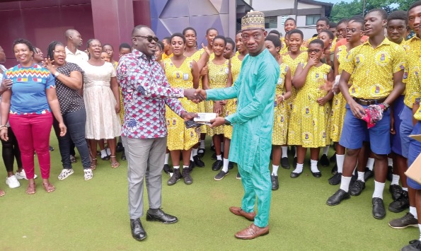 Abdul-Jalil Yakubu (right), Assemblymember of the Tatanaa South Electoral Area, presenting one of the Mathematical sets to Emmanuel Attah-Ashimedu, Headteacher of Madina Methodist Basic School