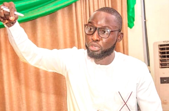 Alhassan Musah Timtooni (left), Minority Leader of the Northern Region Youth Parliament, speaking at the sitting