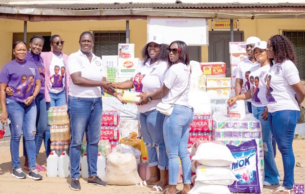 Francisca Ntow (left), PRO of Accra Psychiatric Hospital, receiving the items from Dr Nana Konadu Addo (middle), organiser of the 20th Anniversary Planning Committee, and other members of the year group