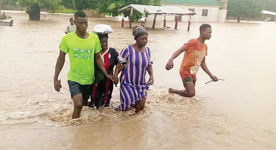 Some residents wading through the flood waters to safety