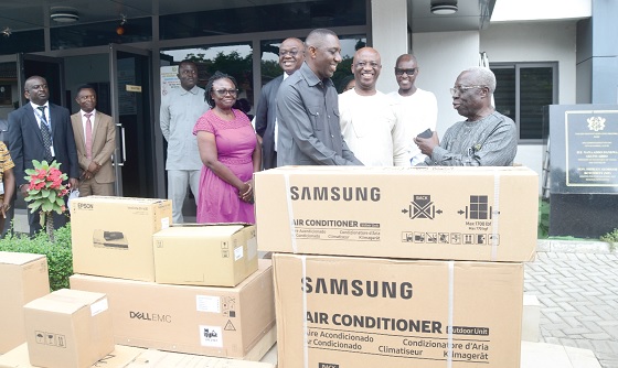 Yaw Osafo-Maafo (right), Senior Presidential Advisor, presenting the equipment to  Mohammed Habib Idris, Director of Passports, while some officials look on. Picture: EMMANUEL QUAYE