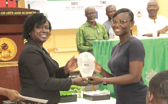 Efua Kayang (left), Director, Finance and Administration, Nuclear Regulatory Authority, presenting a plaque to Juliet Akyaa Safo 