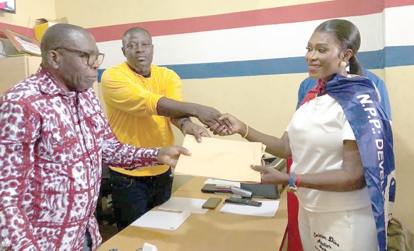 Maame Afia Akoto (right) submitting her nomination forms to Samuel Sackey (left), Chairman of the Constituency Elections and Vetting Committee, and Eric Nana Acquah, Constituency secretary